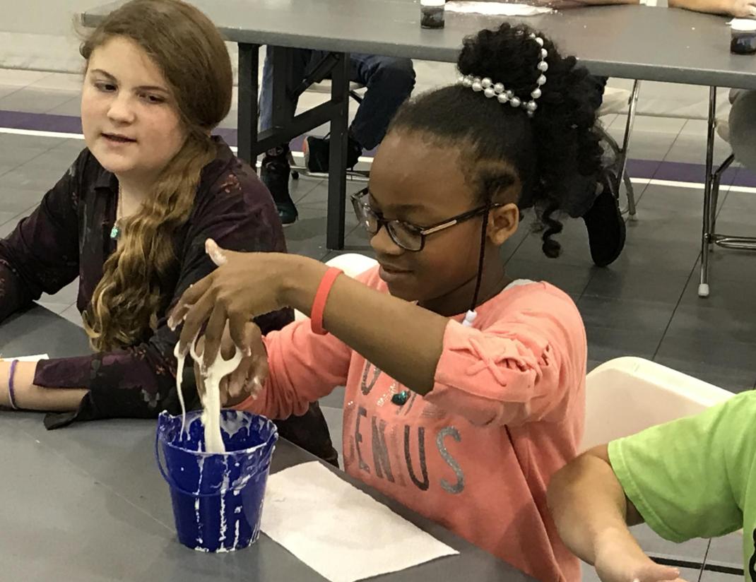 Students handling non-newtonian fluid.