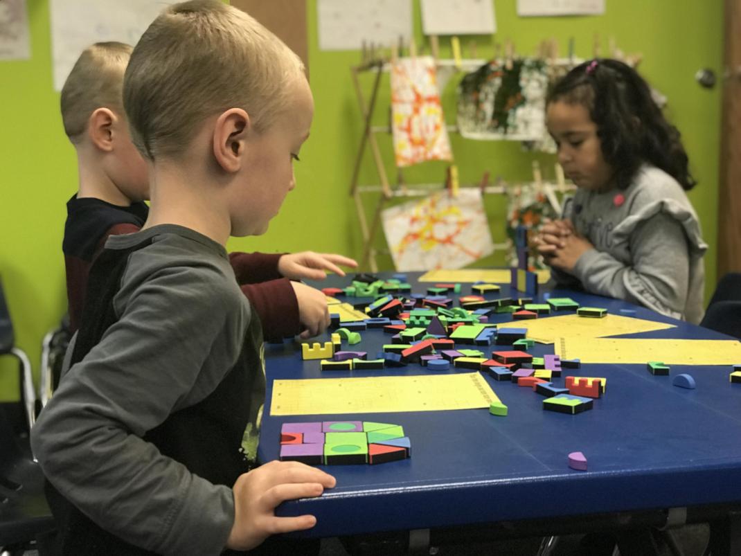 students playing with foam shapes