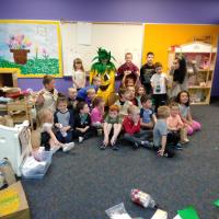 Children pose with Spike during the Grand Opening and ribbon cutting ceremony.